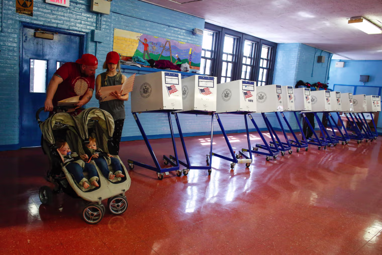 Image: A couple check their documents before they cast their vote