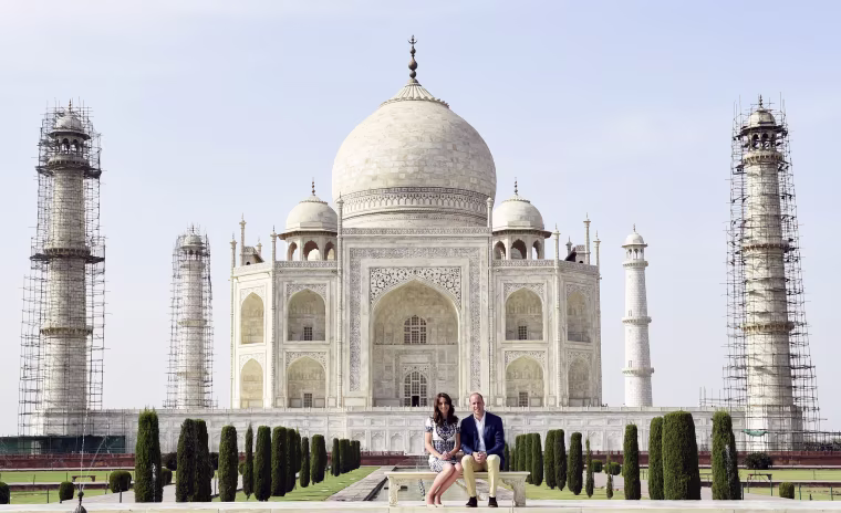 Image: Britain's Prince William and his wife Catherine, the Duchess of Cambridge, pose as they sit in front of the Taj Mahal in Agra