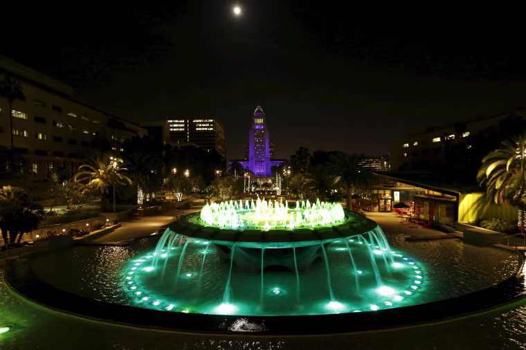 Image: City Hall is illuminated in purple in remembrance of the late singer in downtown Los Angeles, California.