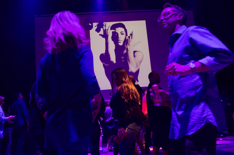 Image: Guests dance to Prince music as a slide show flashes images of the artist during a memorial dance party at the First Avenue nightclub