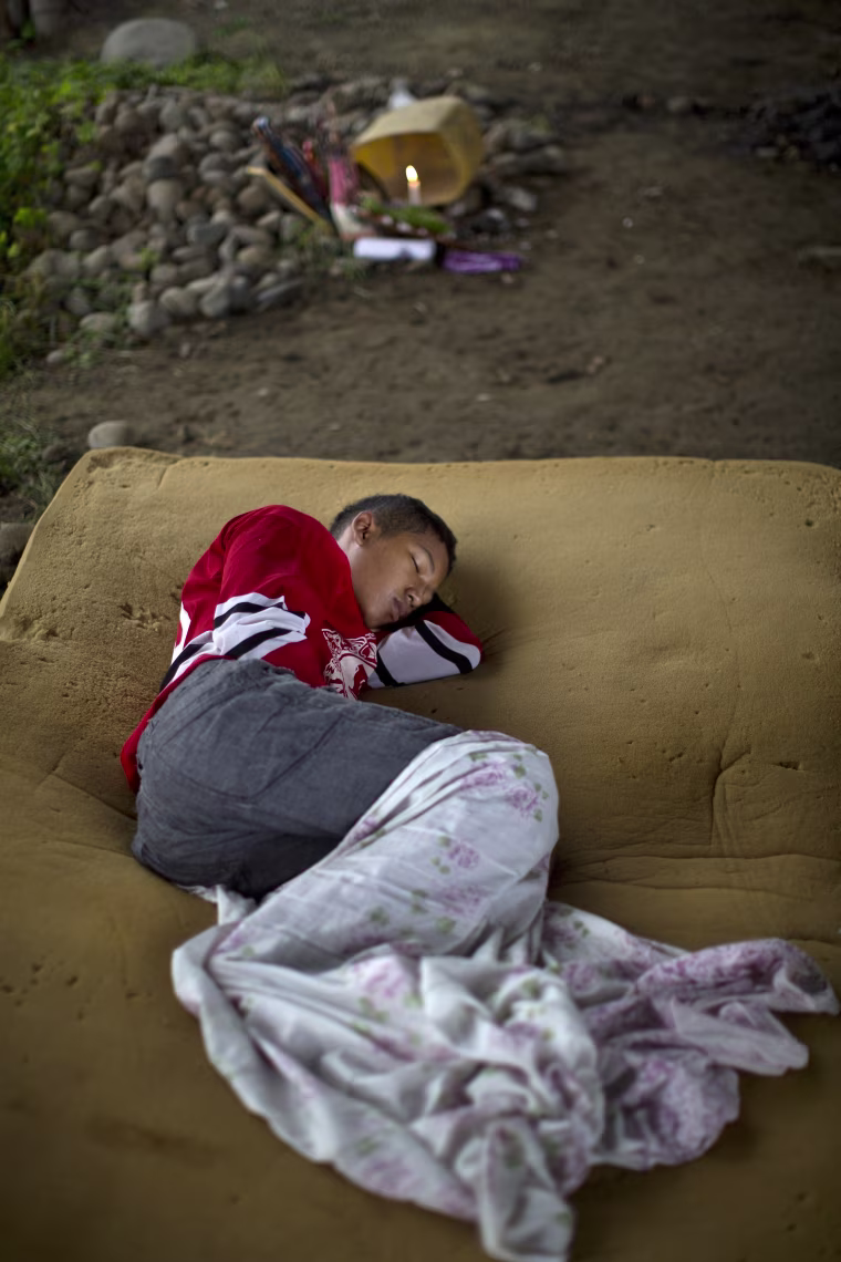 Image: A youth sleeps on a foam mattress after loosing his home in the earthquake in Pedernales, Ecuador