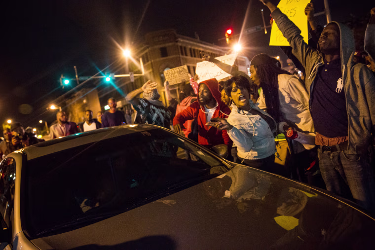 People protesting the death of Freddie Gray and demanding police accountability move into the streets in the Sandtown neighborhood where Gray was arrested on April 30, 2015 in Baltimore, Maryland.