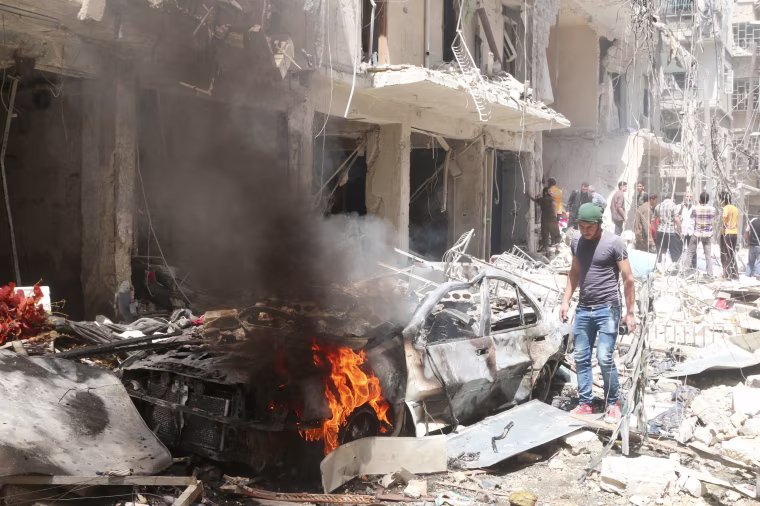 Image: People inspect the damage at a site hit by airstrikes, in the rebel-held area of Aleppo's Bustan al-Qasr