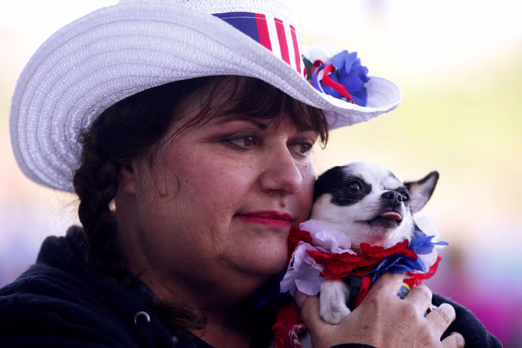 Image: Elaine Theiss waits to hear Republican U.S. presidential candidate Donald Trump speak at a campaign rally in Costa Mesa, California