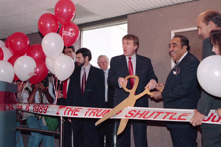 Image: Trump cuts the ribbon during the ceremonies marking the Trump Shuttle's inaugural flight