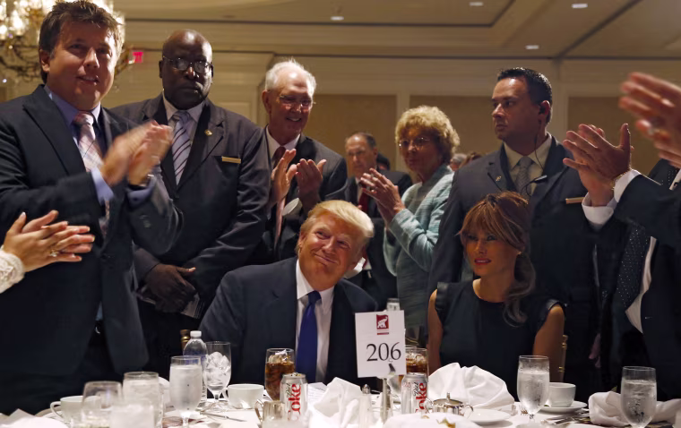 Image: Trump and his wife Melania are applauded before a dinner hosted by the Sarasota Republican Party