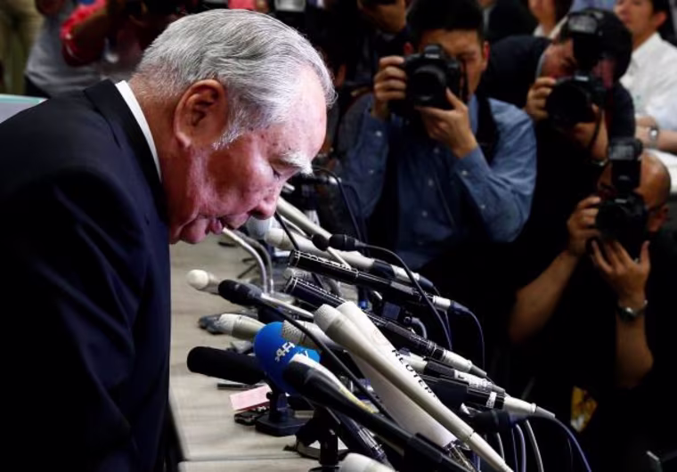 Suzuki Motor Chairman and Chief Executive Officer Osamu Suzuki bows at a news conference at the Land, Infrastructure, Transport and Tourism Ministry in Tokyo, Japan