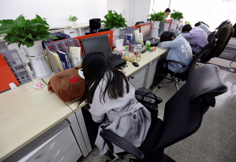 Image: The Wider Image: Working, eating and sleeping at the office