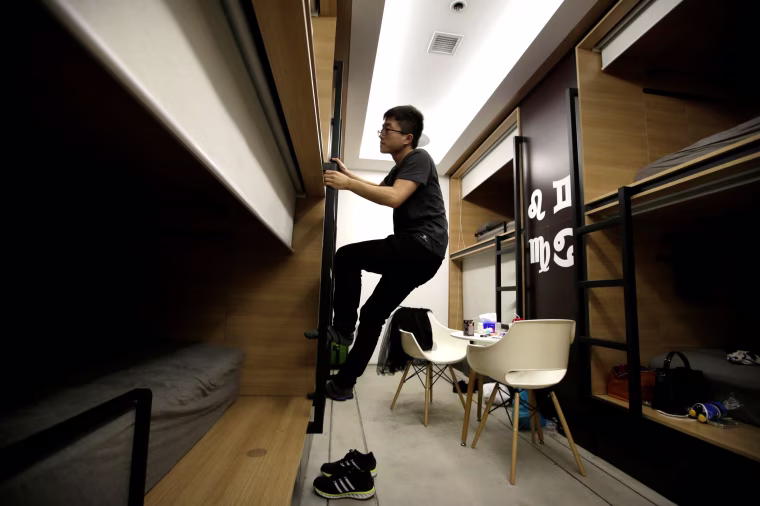 Image: The Wider Image: Working, eating and sleeping at the office
