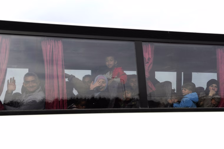Image: Refugees and migrants are transferred on a bus to government camps, during a police operation to evacuate a makeshift camp near the village of Idomeni