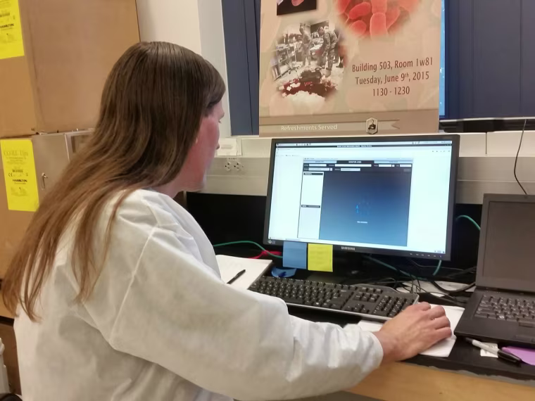 Erik Snesrud of the Walter Reed Army Institute of Research checks bacterial gene sequences.