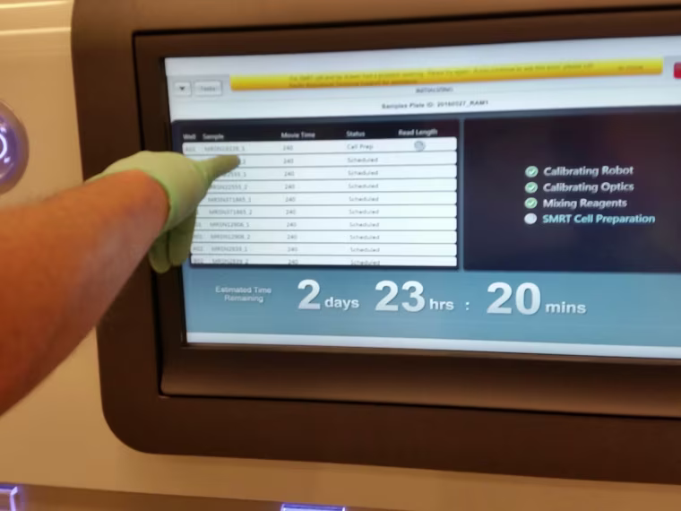 Patrick McGann of the Multidrug Resistant Organism Repository and Surveillance Network (MRSN) lab at Walter Reed Army Institute of Research points to the screen of a Pacific Biosciences PacBio sequencer used to help sequence the genome of a sample of E. coli bacteria that turned out to carry the dreaded mcr-1 resistance gene.
