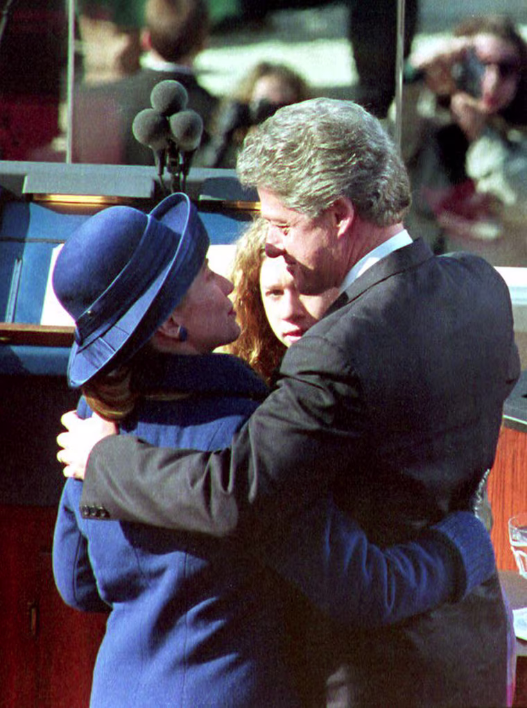 U.S. President Bill Clinton (C) hugs his wife Hill