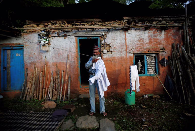 Image: Durga Kami who is studying in the tenth grade at Shree Kala Bhairab Higher Secondary School, prepares his school uniform