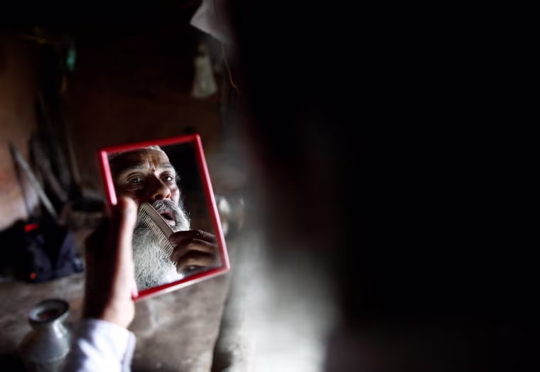 Image: The father of six and grandfather of eight, grooms himself before heading to school