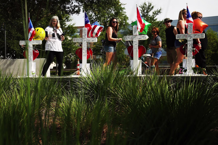 Image: People visit a memorial down the road from the Pulse nightclub