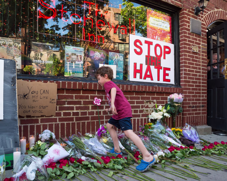 An attendee of the rally places a bouquet of flowers at a