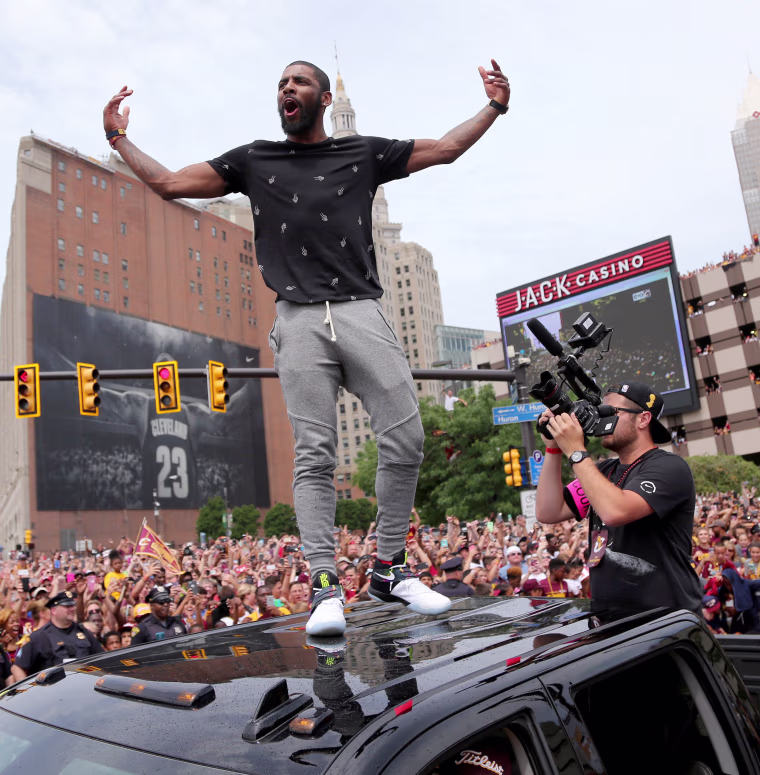 Image: Cleveland Cavaliers Kyrie Irving celebrates with the crowd in downtown Cleveland