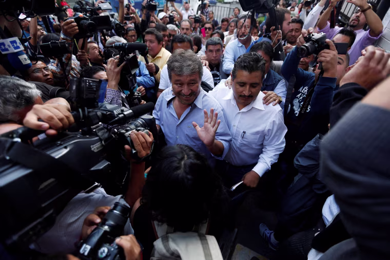 Image: Adelfo Gomez, representative from the CNTE, enters the Interior Ministry building to attend a meeting between members of  the CNTE and Mexico's government in Mexico City