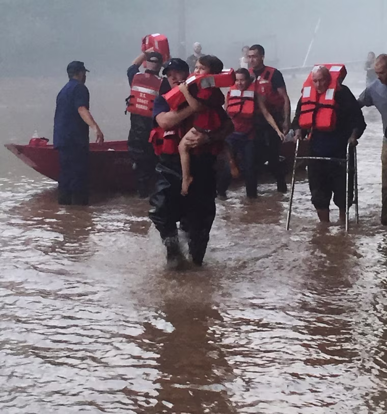 A Coast Guard team helps locals to safety near Clendenin, West Virginia, on June 24, 2016.