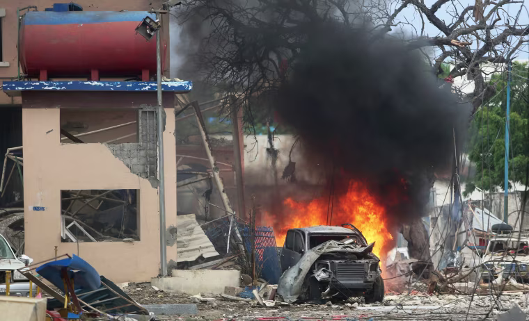 Image: A vehicle burns at the scene of a suicide bomb attack outside Nasahablood hotel in Somalia's capital Mogadishu