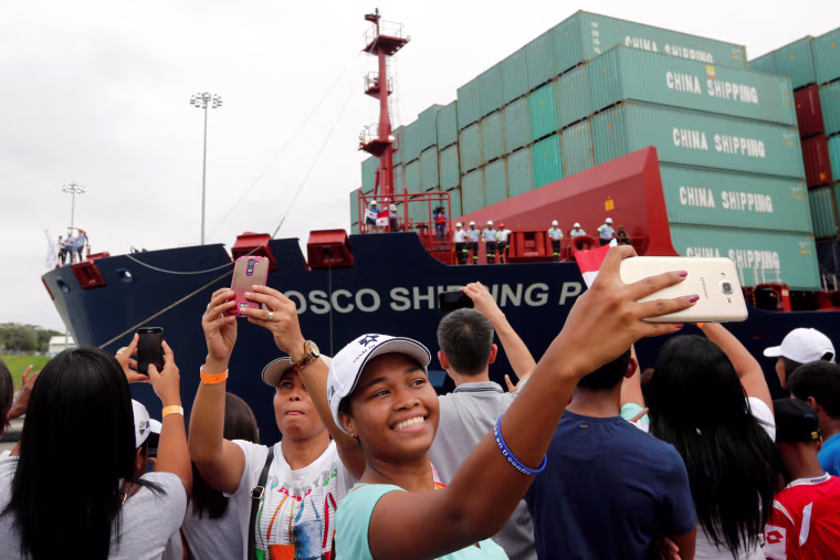 Image: A woman takes a selfie as Chinese COSCO container vessel named Andronikos navigates through the Agua Clara locks during the first ceremonial pass through the newly expanded Panama Canal in Agua Clara