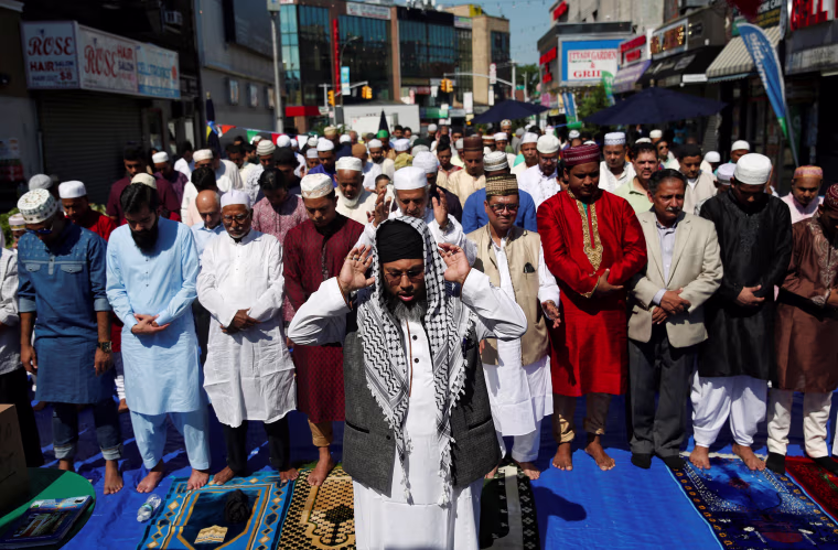 Image: Muslim men attend Eid al-Fitr prayers to mark the end of the holy fasting month of Ramadan in the Queens borough of New York