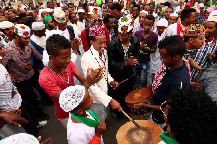 Image: Muslim men sing after attending Eid al-Fitr prayers to mark the end of the holy fasting month of Ramadan in Addis Ababa