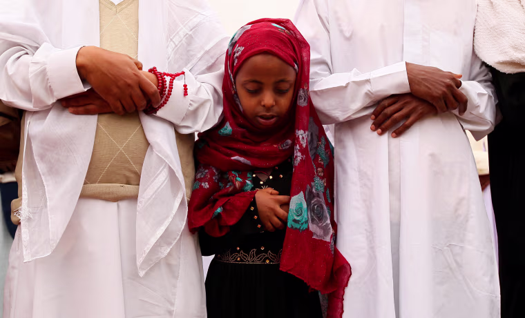 Image: A Muslim girl attends Eid al-Fitr prayers to mark the end of the holy fasting month of Ramadan in Addis Ababa