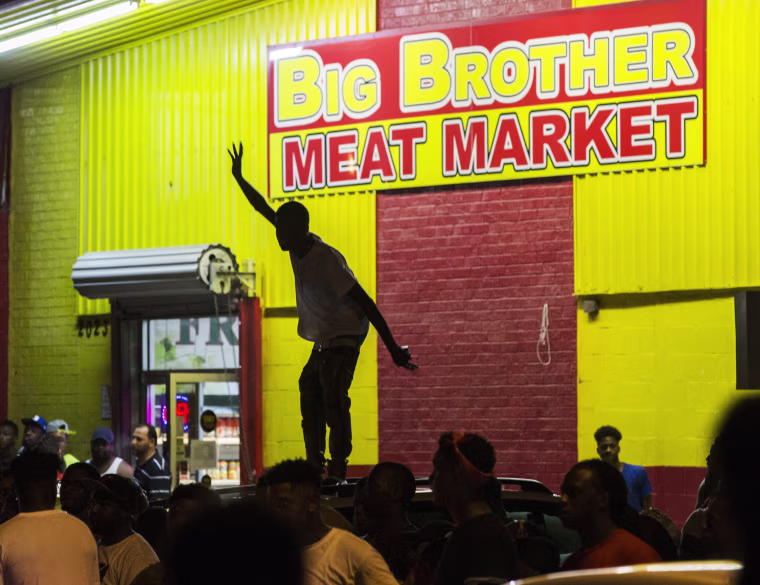 Image: Protesters block traffic and dance on the hood of a car in Baton Rouge