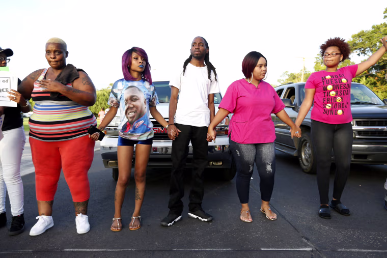 Image: A group of protesters demonstrate near a prayer vigil in memory of Alton Sterling, who was shot dead by police, in Baton Rouge, Louisiana