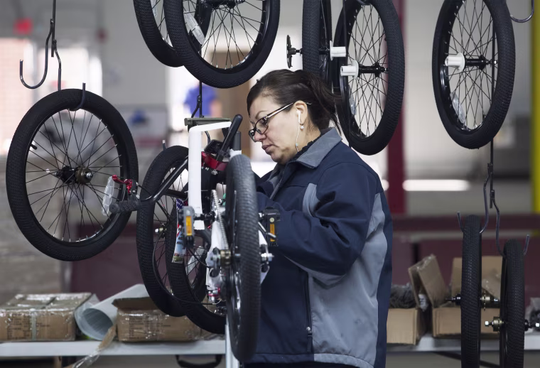Nancy Bocanegra of Sumter, South Carolina installs brake cables at the new Bicycle Corporation of America plant in Manning, South Carolina