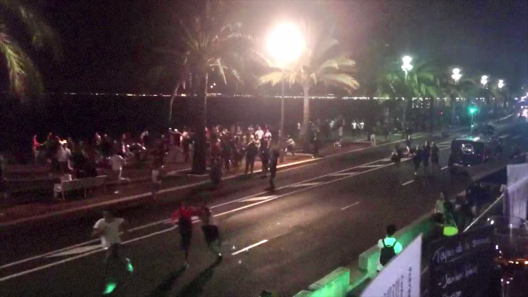 Image: People run away from the scene of an attack in the French Riviera city of Nice.