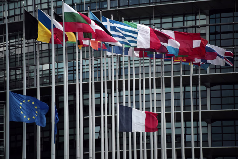 Image: The French and European Union flags fly at half-mast in front of the European Parliament