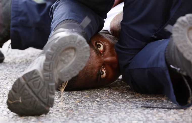 Image: A man protesting the shooting death of Alton Sterling is detained by law enforcement near the headquarters of the Baton Rouge Police Department in Baton Rouge, Louisiana