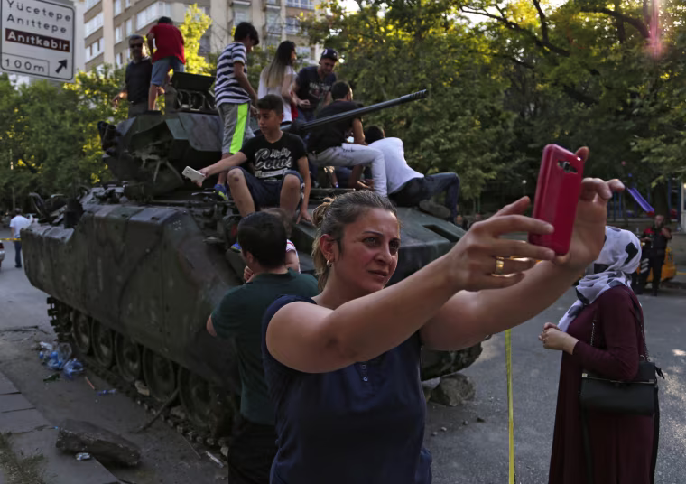 Image: Woman takes a self near Turkish military vehicle on July 16, 2016