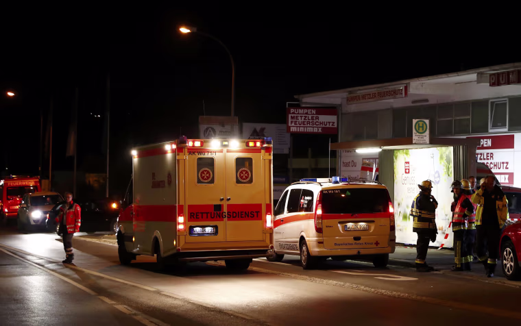 Image: German emergency services workers work in the area where a man with an axe attacked passengers on a train