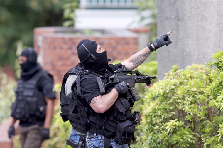 Image: Members of French special police forces of Research and Intervention Brigade (BRI) are seen at the scene during a raid after a hostage-taking in the church in Saint-Etienne-du-Rouvray