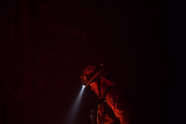 Image: Firefighter Brendon Gorman pauses while battling the Soberanes Fire along Palo Colorado Road near Big Sur