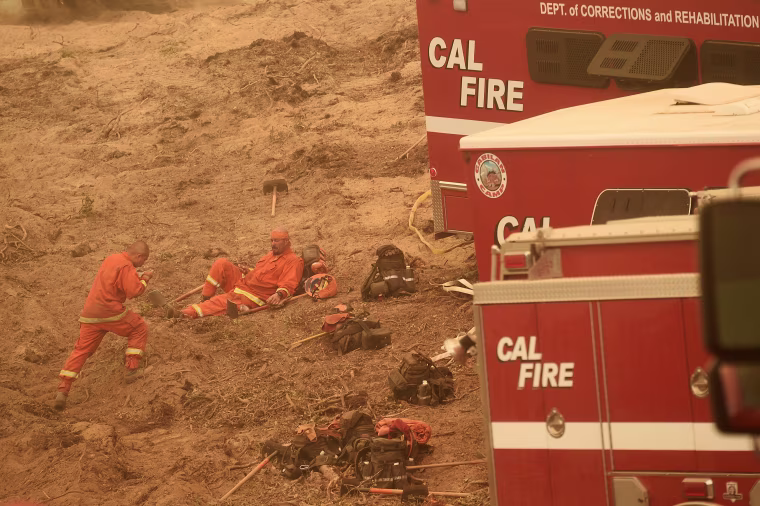 Image: Inmate firefighters rest before constructing a fire break to stop the Soberanes Fire in Carmel Highlands