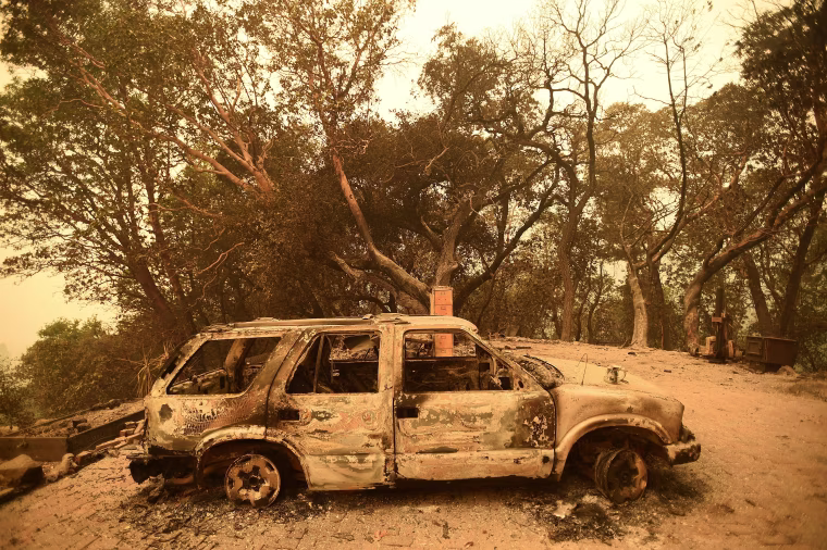 Image: A burned car rests in the driveway of a Palo Colorado area residence leveled by the Soberanes Fire near Big Sur