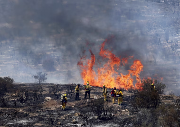 Image: Firefighters let a small area of the Sand Fire burn out near Acton