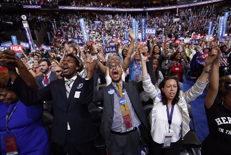 Image: Delegates sing together on the convention floor during the fourth and final night at the Democratic National Convention in Philadelphia