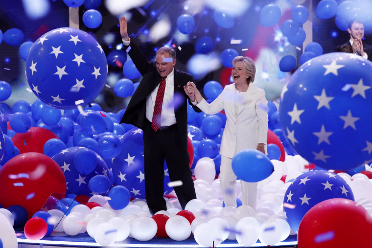 Image: Kaine and Clinton walk through balloons at the end of the DNC
