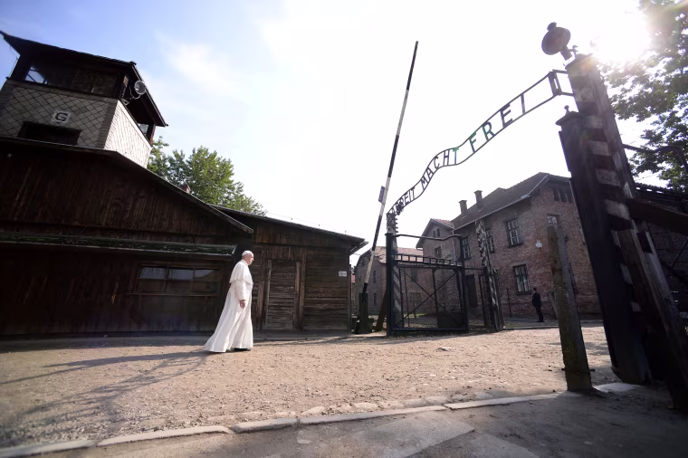 Image: Pope Francis walks through Auschwitz's notorious gate during his visit to the former Nazi death camp