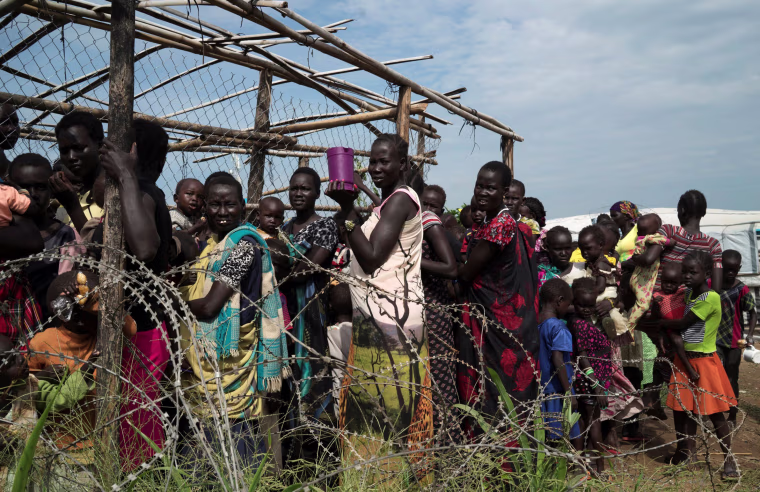 Image: Women and children queue to receive emergency food