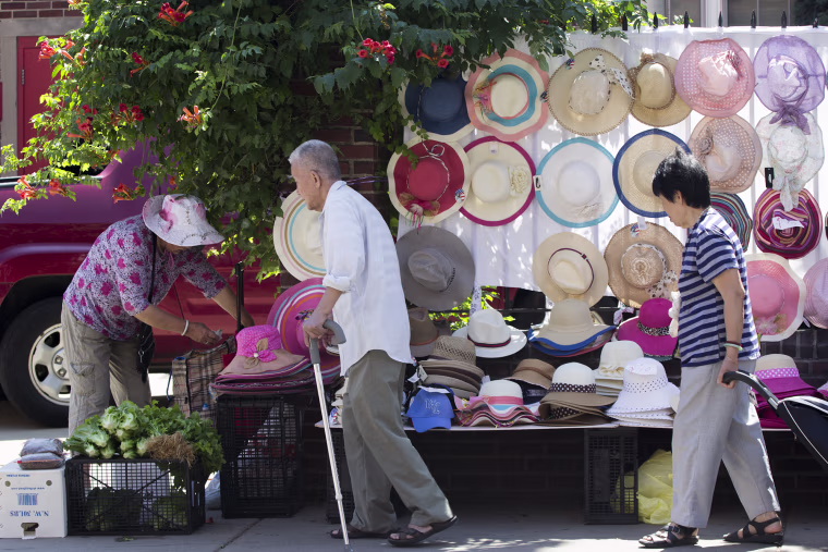 Customers stroll by sidewalk shops set up in Philadelphia's industrial Chinatown area.