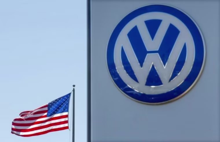 An American flag flies next to a Volkswagen car dealership in San Diego, California