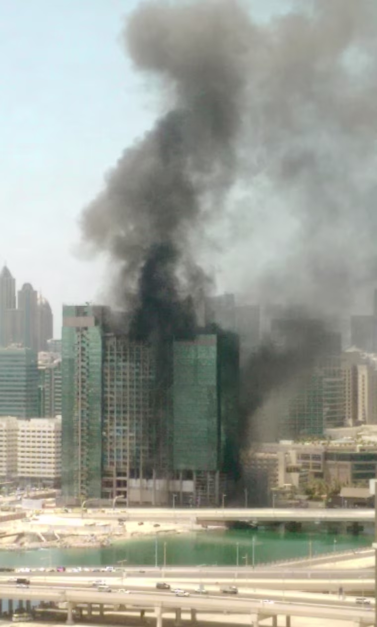 Image: Smoke rises from a blaze in a high-rise building under construction in Abu Dhabi, United Arab Emirates.