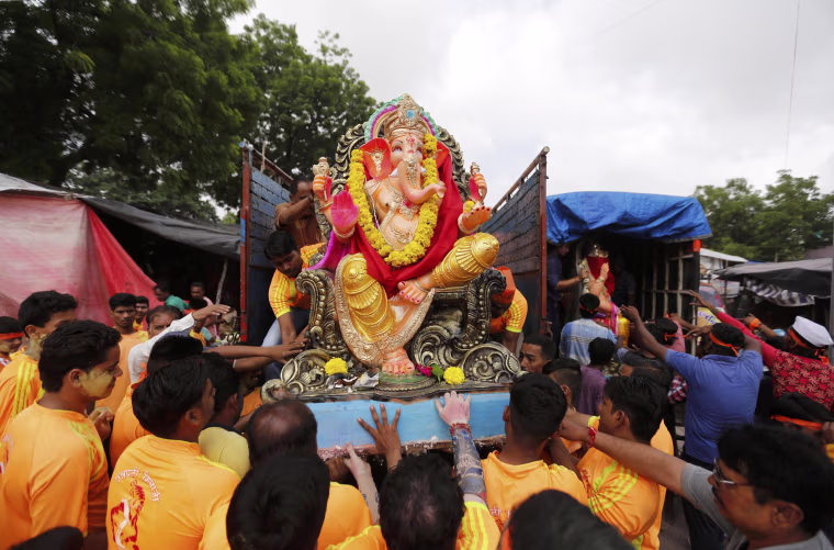 Image: An idol of the Hindu god Ganesh is loaded onto a supply truck on the first day of the Ganesh Chaturthi festival in Ahmedabad